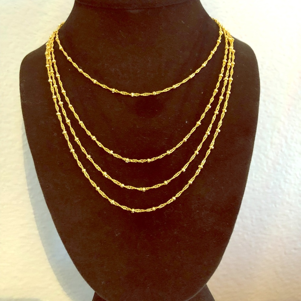 Multi chain gold metal necklace.